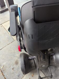 curved plastic piece on top of the powerchair seat back
