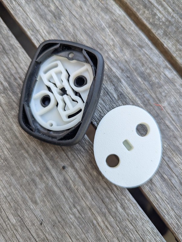 view of the inside of two plastic joystick interiors, one with holes in it and a worn out inner slot; the other freshly printed, solid, and robust