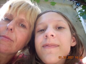 a girl with her mother, their faces close together