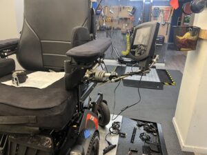 view of the mounting hardware for a swing-away table on a powerchair