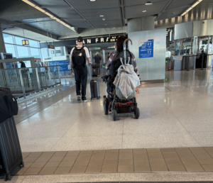 shot from behind as a person in a powerchair approaches the san francisco airport departure gate