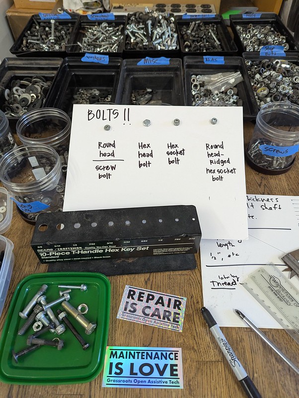bolts arranged in many little containers and a card displaying different varieties of small hardware