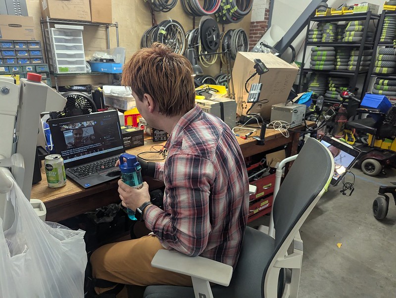 Olga at a crowded workbench setting up zoom cameras for Learningn Labs